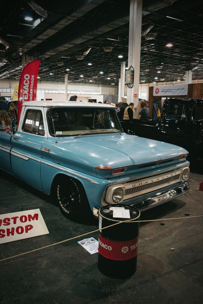 services-03 Classic blue Chevrolet truck on display at a Hungarian motor show indoor event.