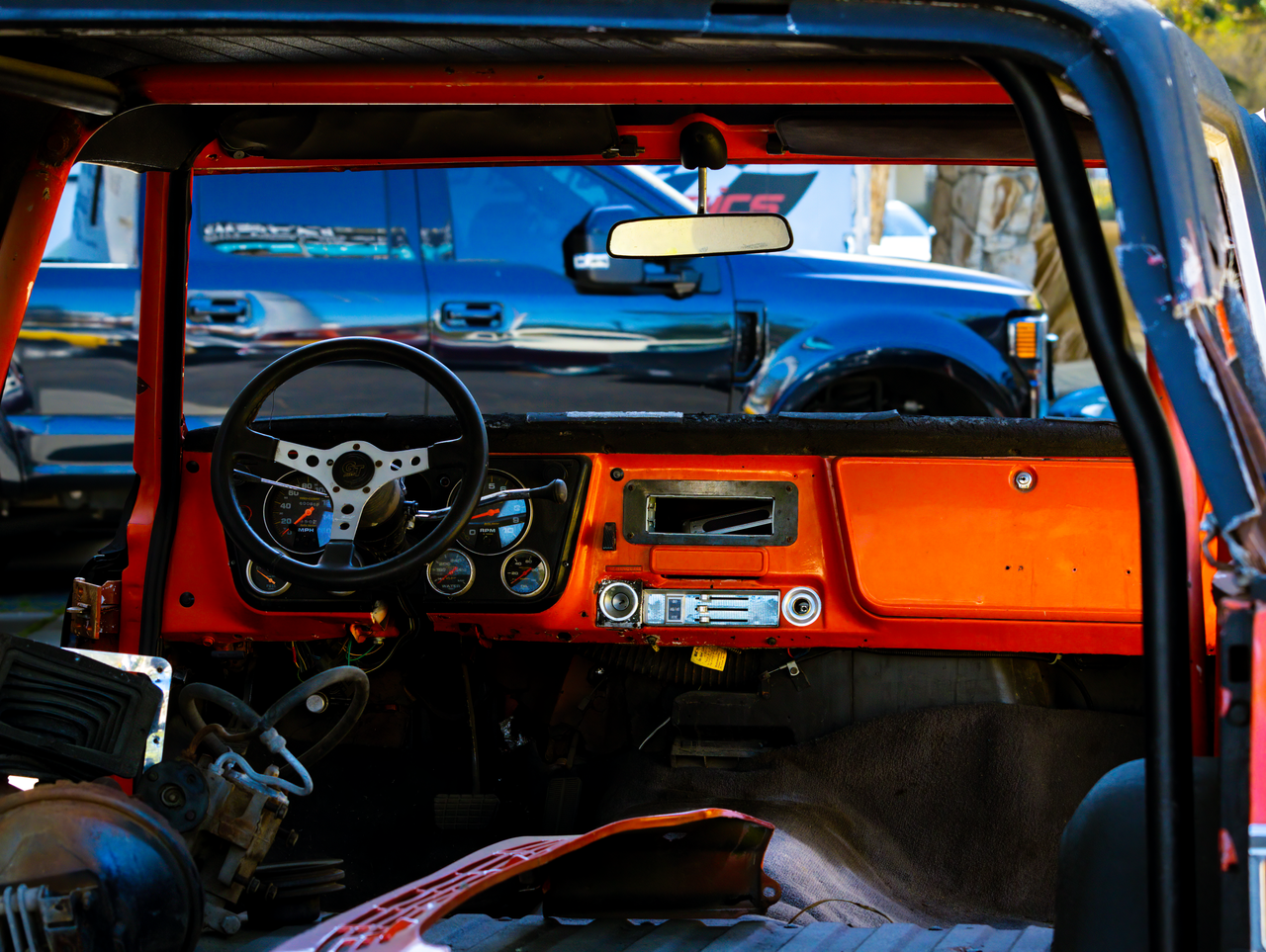 services-02 Close-up of a classic car interior featuring a vintage dashboard and steering wheel.